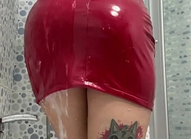 Latex fetish  Dominatrix Nika takes a shower in a red latex dress
