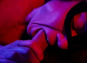 A imperceivable woman sucks a big cock with an ending in her mouth a gentle blowjob in neon light to the music