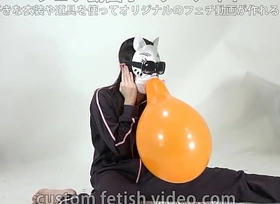 A girl inflates and splits a balloon