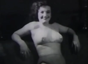 A mature lady with reference to dark sericeous hair takes part in the filming of a 60s porn cagoule
